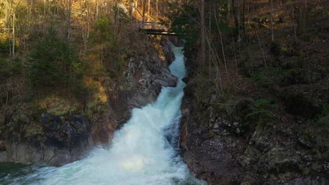 Rindbach Waterfall rushing through rocky gorge under wooden bridge in Ebensee Видео 345678130