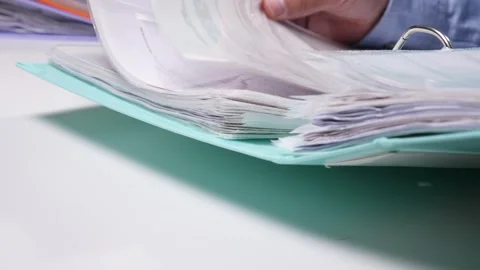 Ring binder with numerous organized documents and important paperwork Stock Footage 342771436