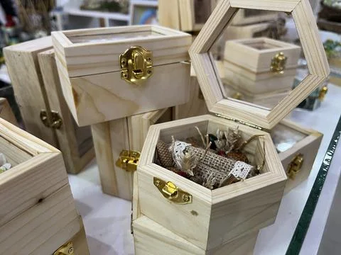 Ring boxes with wood base and bohemian ornaments in a store Stock Photos