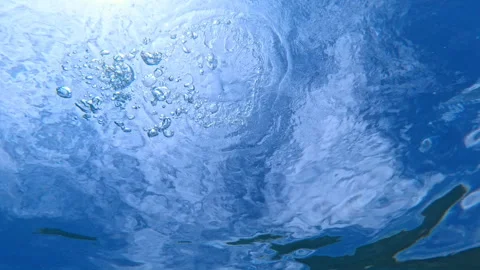 Ring bubble and sunlight underwater in blue ocean. Stock Footage 337725419