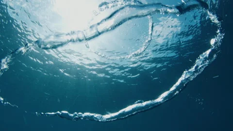 Ring bubbles move underwater, collide and make new tiny bubble Stock Footage 251180156