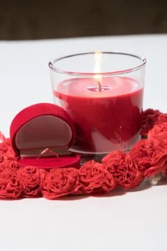 The ring in a case in the form of a heart stands on a white table. Composition Stock Photos