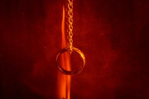 Ring on a chain on the flame background Stock Photos
