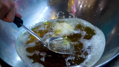 Ring donuts are fried in an automatic deep fryer in hot vegetable oil. 4K Stock Footage 313118105