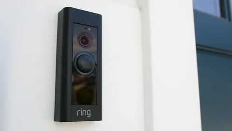 Ring Doorbell lights up a blue ring once doorbell is rung.  Editorial clip. Stock Footage 103347399