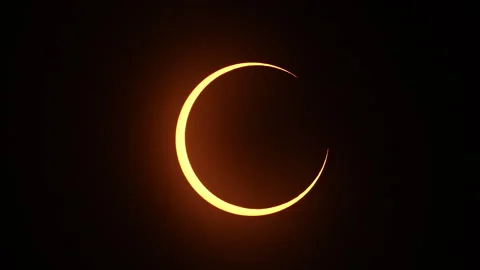 Ring of Fire annular solar eclipse taking place as the moon covers the sun Stock Footage 253299532