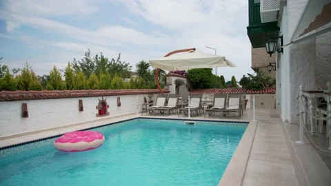 Ring floating in a refreshing blue swimming pool Stock Footage 133565924