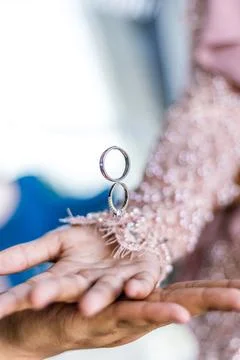 Ring flying over hands. coupled hands, groom and bride and wedding rings Stock Photos
