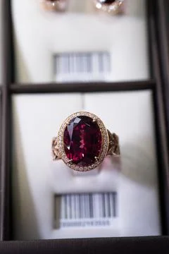 Ring with huge ruby and diamonds. close up. beauty and fashion concept Stock Photos