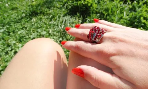 Ring jewellery with red ruby crystals on finger Stock Photos