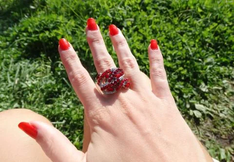 Ring jewellery with red ruby crystals on finger 库存照片