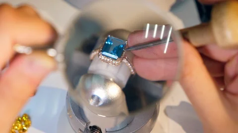 A ring with jewels in progress seen through the magnifier Video stock 112946486
