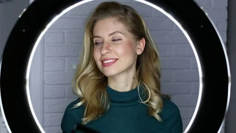 Ring LED flash. Close up blue eyes, Portrait of a young happy blonde woman Stock Footage 73999141