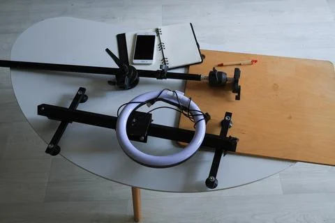 Ring light and smartphone setup for content creation on a table Stock Photos