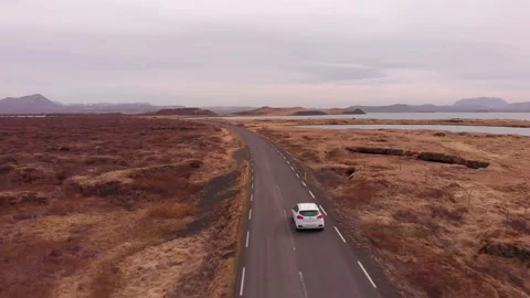 Ring Road (Route 1) alongside Myvatn Lake in North Iceland with cars passing by Stock Footage 130853477