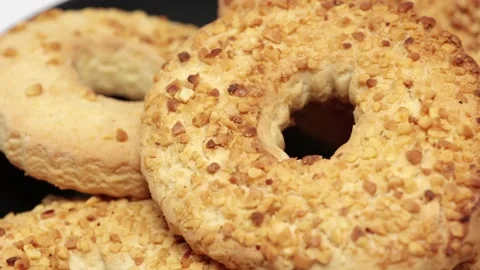 A Ring Of Shortbread Cookies With Peanuts Rotates On A Black Plate On White Back Stock Footage 238035561