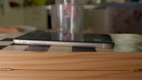 Ring from smartphone resting on kitchen table in morning light Видео 333906486
