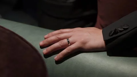 Ring On Sofa, Contemplative Hand Resting Quietly, Quiet Moment Captured With Stock Footage 323776069