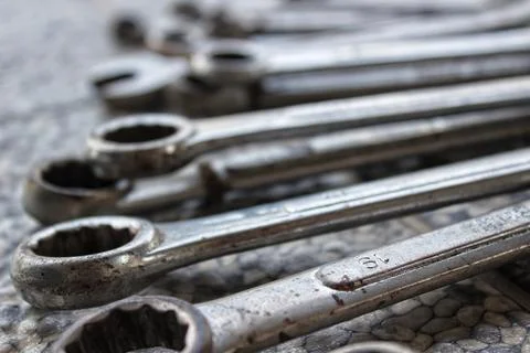 Ring wrenches of various sizes scattered on the floor Stock Photos