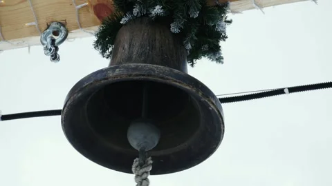 The ringer pulls the rope of a bronze bell. Stock Footage 168730379