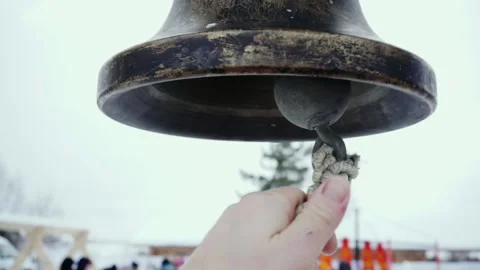 The ringer pulls the rope of a bronze bell. Stock Footage 168730597