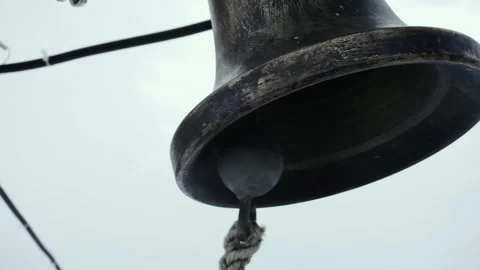 The ringer pulls the rope of a bronze bell. Stock Footage 170364768