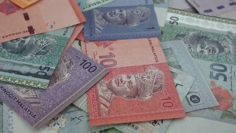 Ringgit Malaysia banknotes of various values are scattered on the table. Stock Footage 95769768