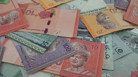 Ringgit Malaysia banknotes of various values are scattered on the table. Stock Footage 95770487