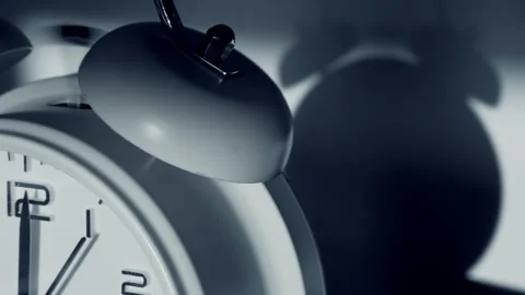 Ringing alarm clock, with its shadow behind. Stock-Footage 148874510