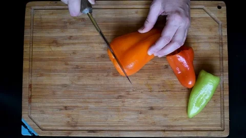 Rings of bell pepper of different colors on a wooden Board background Stock Footage 95507643