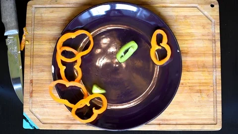 Rings of bell pepper of different colors on a wooden Board background Stock Footage 95564625