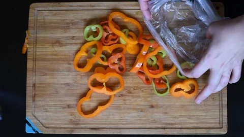 Rings of bell pepper of different colors on a wooden Board background Video stock 95765877