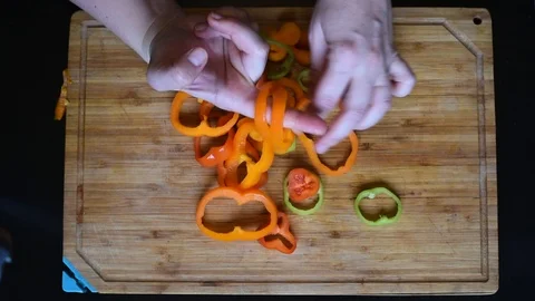 Rings of bell pepper of different colors on a wooden Board background Stock Footage 95765883