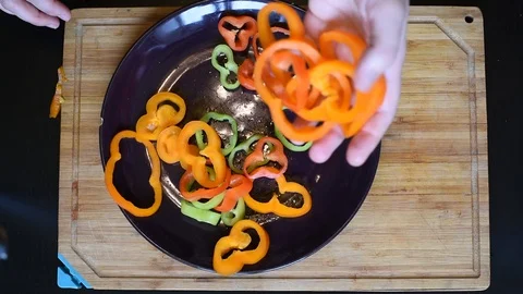 Rings of bell pepper of different colors on a wooden Board background Stock Footage 96058253