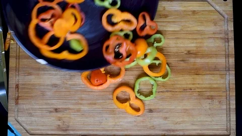 Rings of bell pepper of different colors on a wooden Board background Stock Footage 96065266
