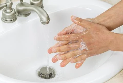 Rinsing soap off hands Stock Photos