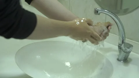 Rinsing-soapy-hands-under-running-water-sink Stock Footage 344804100