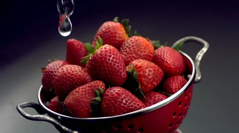 Rinsing strawberries in colander Stock-Footage 61663841
