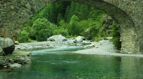 Rio Ara river and bridge San Nicolas de Bujaruelo in Ordesa Aragon Huesca Spain Stock Footage 41556708