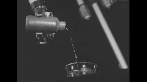 RIO DE JANEIRO - 1961 - Robotic arms pour radioactive chemicals into a flask at Stock Footage 340587157