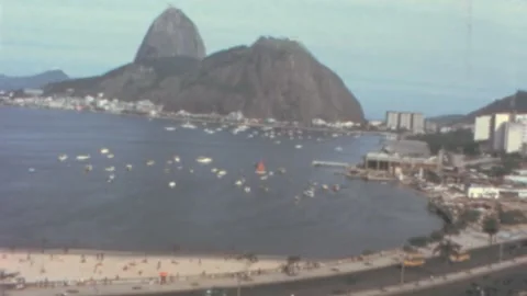 Rio de Janeiro - 1962: panoramic view people in beach with cars pass on highway Stock Footage 218737015