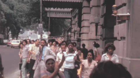Rio de Janeiro - 1977: men woman walk in street pass each other in latin america Stock Footage 233267600