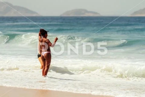 Rio de Janeiro, Brazil - August 24, 2018: Two friends, one Caucasian and anot Stock Photos
