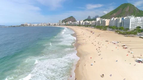 RIO DE JANEIRO, BRAZIL- MAY 2023: Fly above famous Copacabana beach and Atlantic Stock Footage 240576576