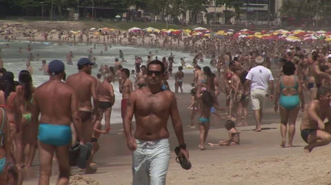 Rio de Janeiro: Man Walks Down Crowded Beach Stock Footage 46971851