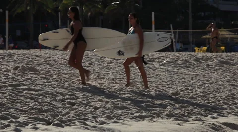 Rio de Janeiro: Two Female Surfers Walk Through Frame Stock Footage 45332593