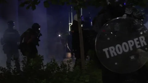 Riot police split protest crowd with tear gas Stock Footage 231909128