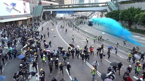 Riot police vehicles officers move on running protesters, water cannon Hong Kong Stock Footage