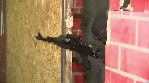 A riot policeman fires an automatic weapon during a training session. Stock Footage 174676305