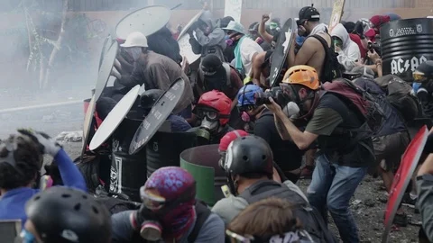 Rioters hide behind shields during a civil protest in Santiago, Chile Video stock 124219611